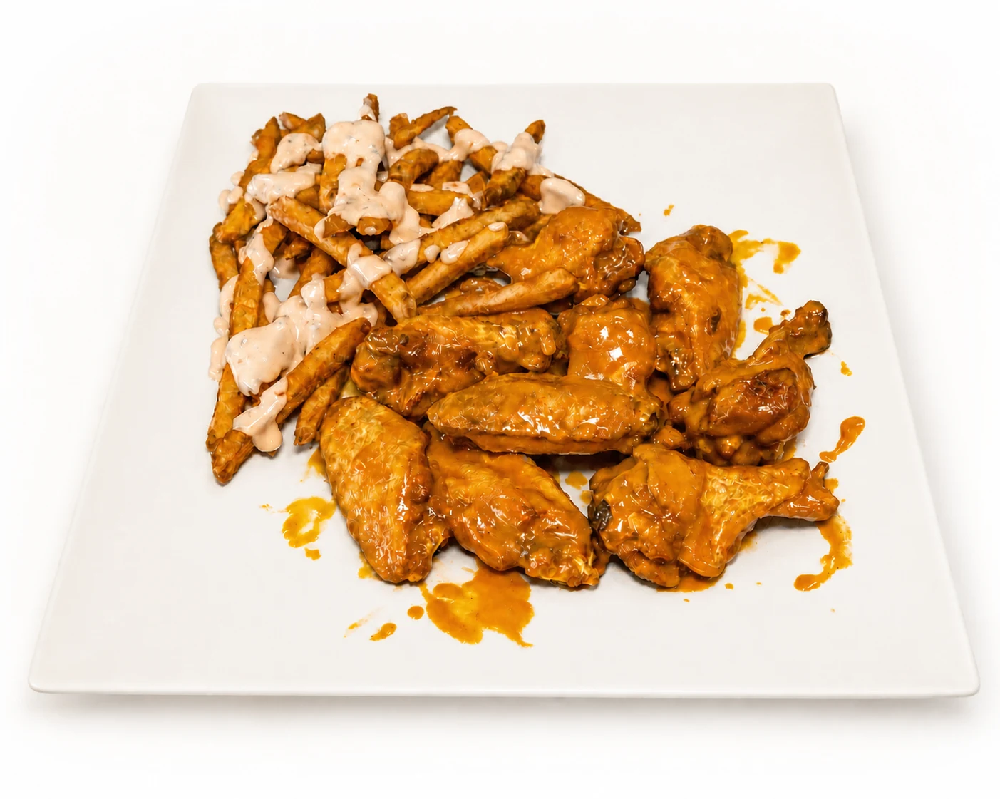 Sauced chicken wings served with fries